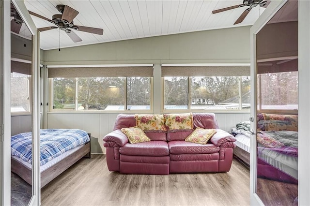bedroom featuring wood finished floors, a ceiling fan, and lofted ceiling