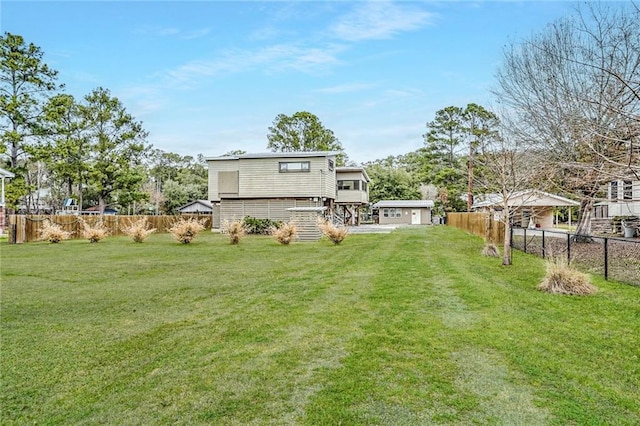 back of property featuring a yard and a fenced backyard