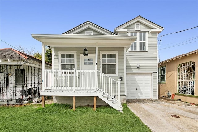 view of front facade with covered porch, a front yard, and a garage