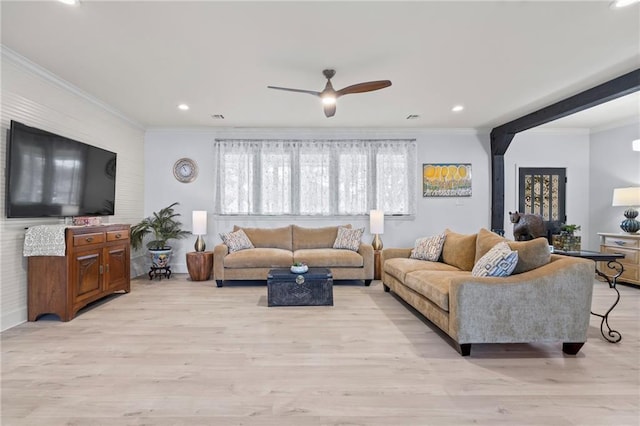 living room with crown molding, ceiling fan, and light wood-type flooring