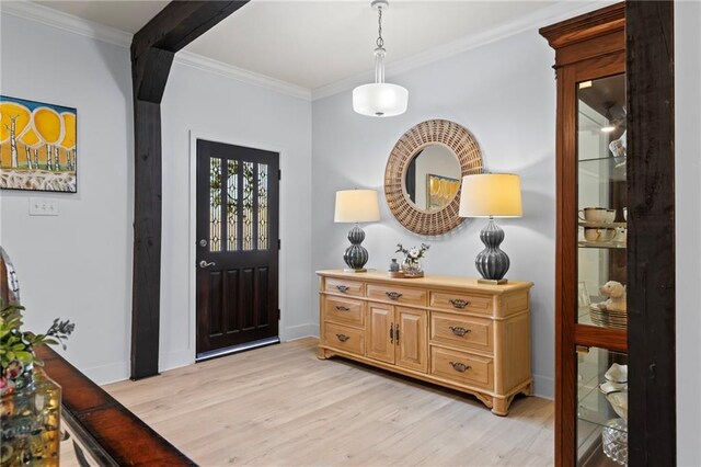 foyer featuring ornamental molding and light hardwood / wood-style floors