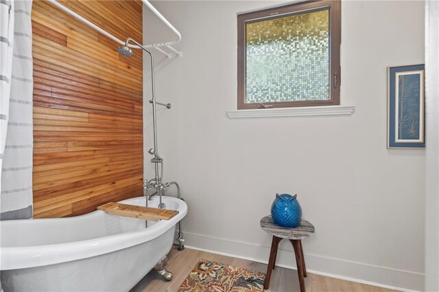 bathroom featuring hardwood / wood-style floors and a tub