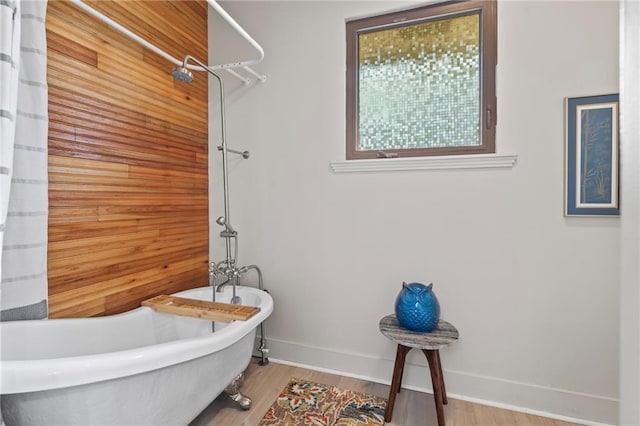 3845 Monroe St, Mandeville, LA 70448 - bathroom featuring baseboards, curtained shower, wood finished floors, and a soaking tub