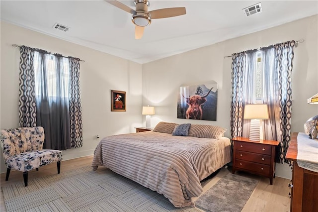 3845 Monroe St, Mandeville, LA 70448 - bedroom with visible vents, wood finished floors, and multiple windows