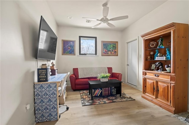 living room with ceiling fan and light wood-type flooring