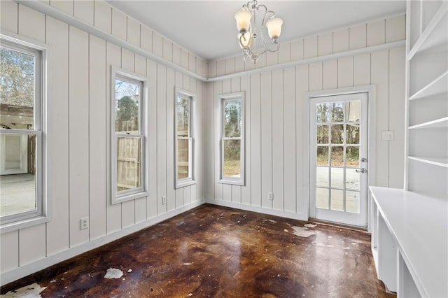 unfurnished sunroom with a chandelier