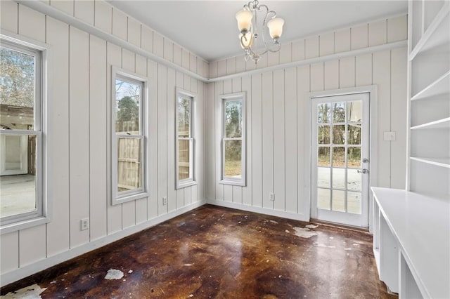 3845 Monroe St, Mandeville, LA 70448 - unfurnished dining area with concrete floors, a chandelier, and plenty of natural light