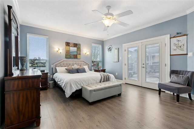 bedroom featuring wood-type flooring, access to outside, ceiling fan, crown molding, and french doors