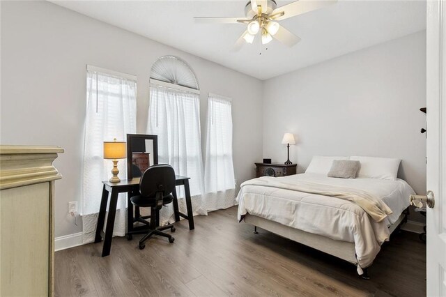 bedroom with hardwood / wood-style floors and ceiling fan