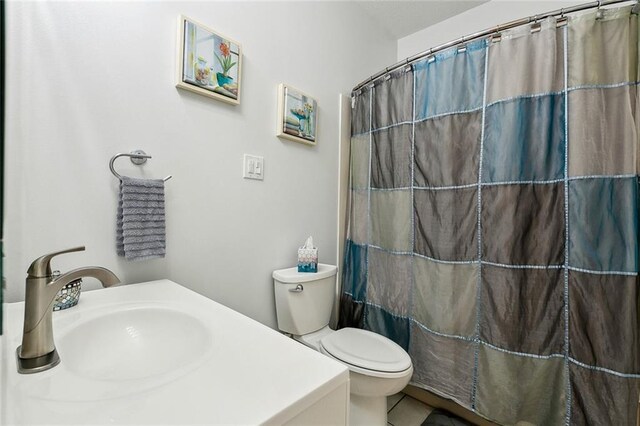 bathroom featuring walk in shower, sink, and toilet