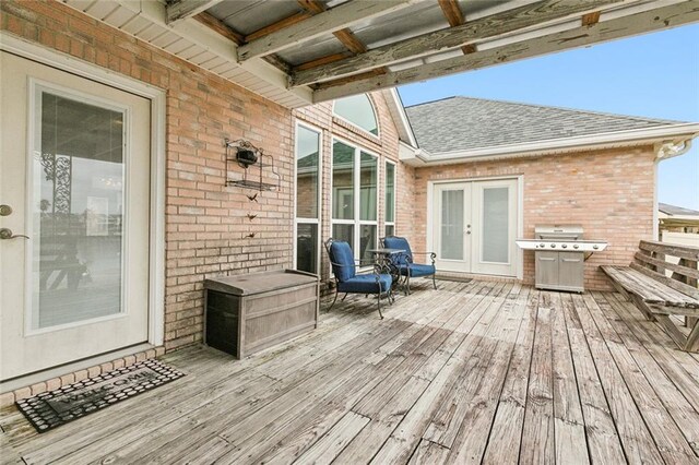 wooden terrace with french doors and a grill