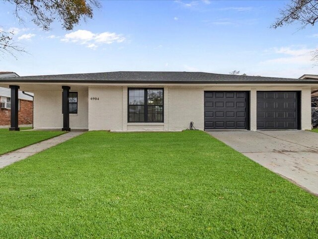 ranch-style home with a garage and a front yard