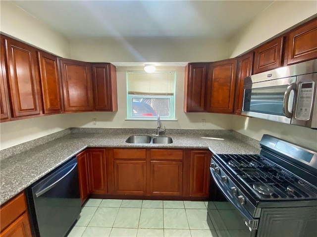 kitchen with light tile patterned flooring, sink, and black appliances