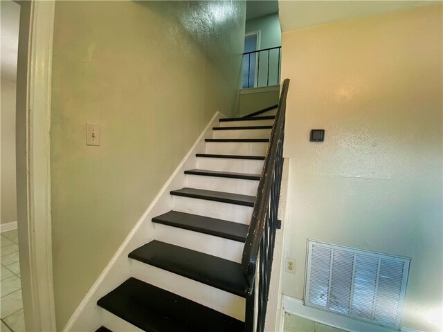 stairs with tile patterned flooring