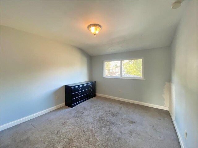 spare room featuring light colored carpet