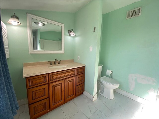 bathroom featuring vanity and toilet