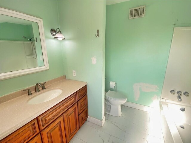 full bathroom featuring vanity, bathtub / shower combination, and toilet