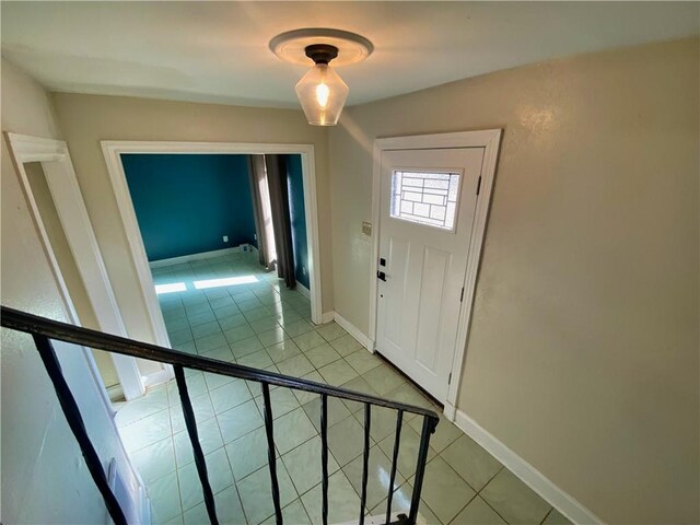 entryway featuring light tile patterned floors