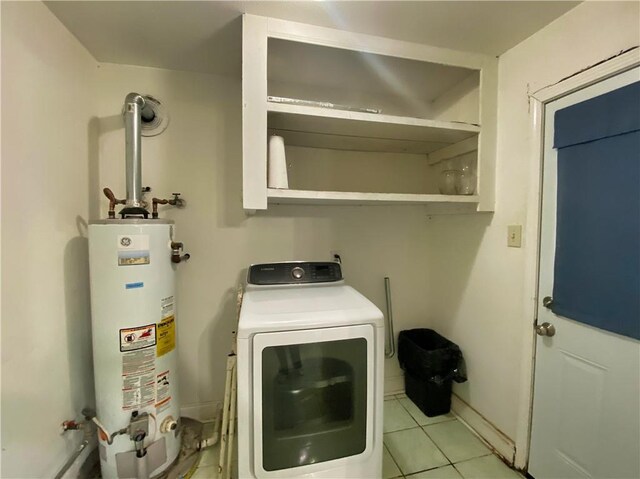 washroom featuring light tile patterned flooring, washer / dryer, and gas water heater