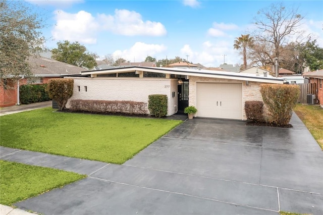 single story home with a garage, a front lawn, and central air condition unit