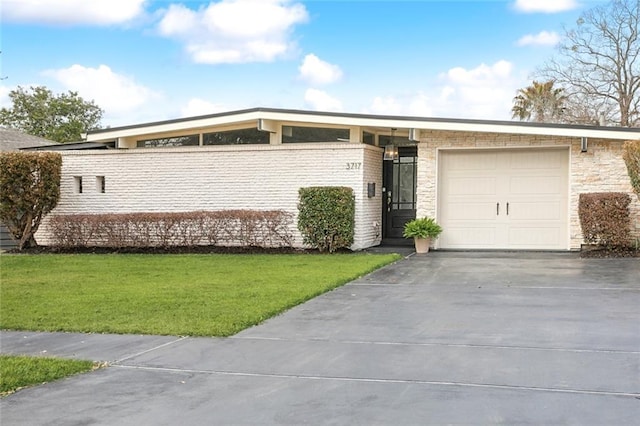 ranch-style home with a garage and a front lawn