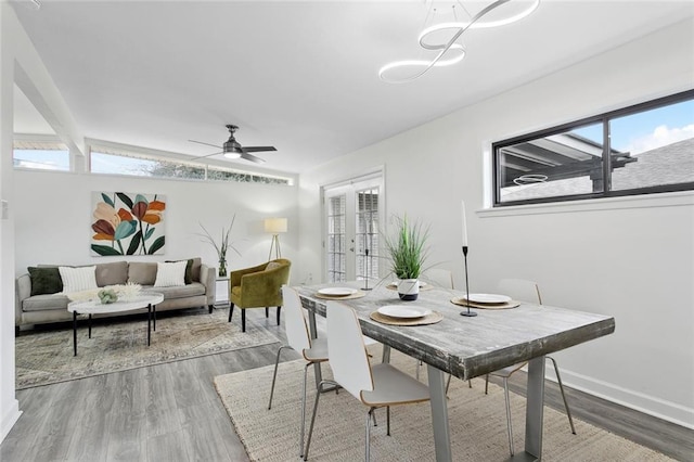 dining area with wood-type flooring, french doors, and ceiling fan