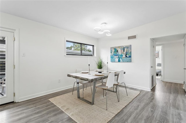 dining area featuring dark wood-type flooring