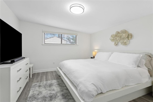 bedroom with dark wood-type flooring