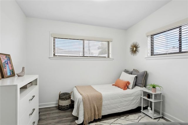 bedroom with multiple windows and hardwood / wood-style floors