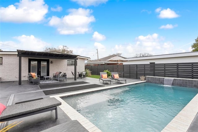 view of swimming pool with a patio, pool water feature, and french doors