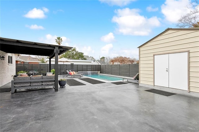 view of swimming pool featuring an outdoor hangout area, a shed, and a patio