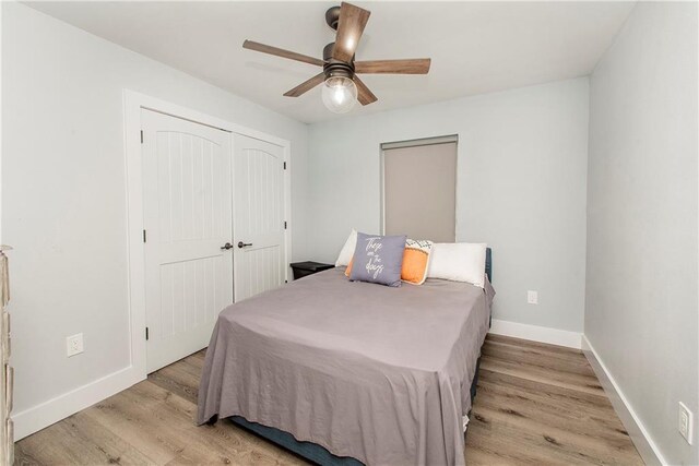 bedroom featuring light hardwood / wood-style flooring, a closet, and ceiling fan