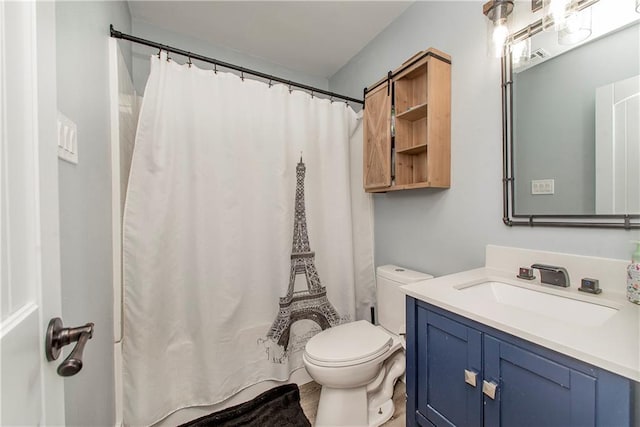 bathroom featuring vanity and toilet