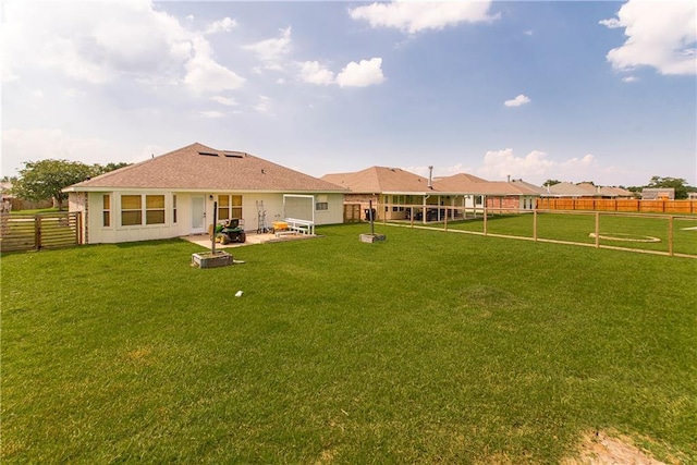 rear view of property with a patio area and a lawn