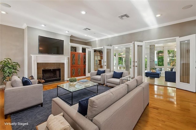 30302 Ashley Dr, Lacombe, LA 70445 - living room featuring ornamental molding, visible vents, french doors, and light wood-style floors