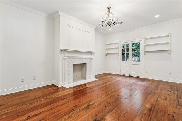 unfurnished living room with ornamental molding, a chandelier, and wood-type flooring