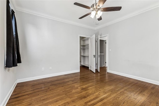 unfurnished bedroom with crown molding, dark hardwood / wood-style floors, and ceiling fan