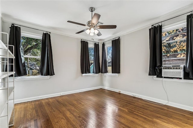 empty room with hardwood / wood-style flooring, ornamental molding, and ceiling fan