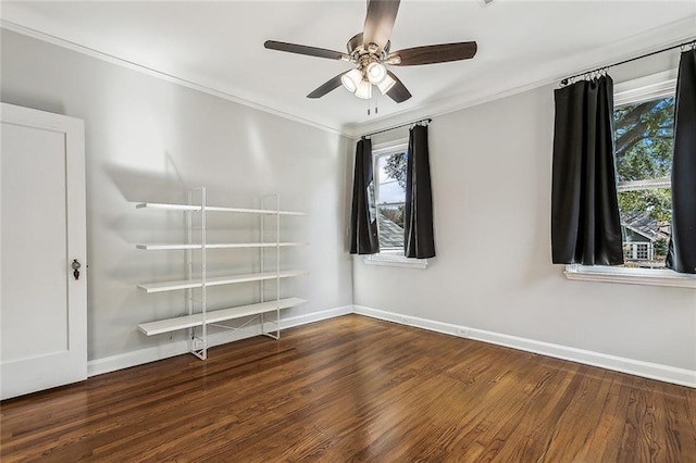 unfurnished room with dark wood-type flooring, ceiling fan, crown molding, and a wealth of natural light