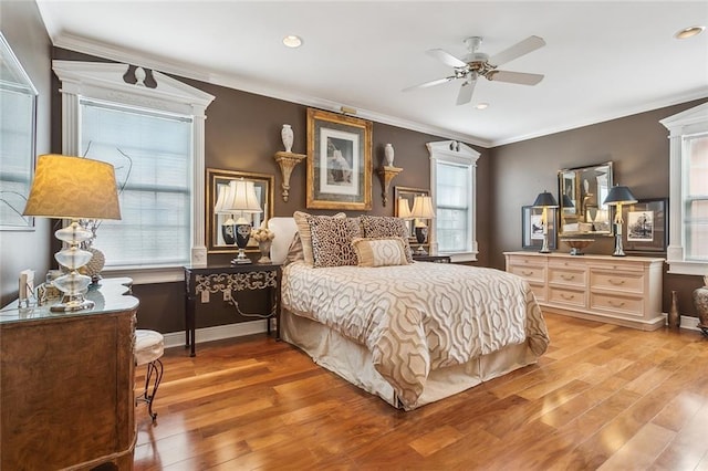 bedroom with ceiling fan, ornamental molding, and hardwood / wood-style floors