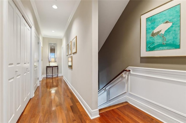 corridor featuring ornamental molding and wood-type flooring