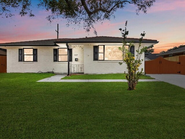 ranch-style house with a carport and a front yard