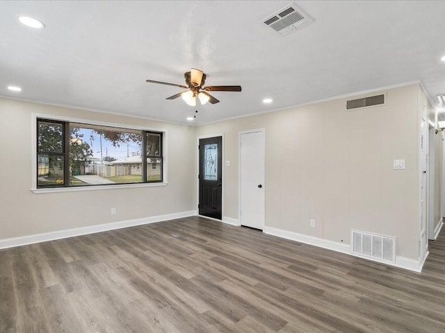 unfurnished room with ceiling fan, ornamental molding, and dark hardwood / wood-style floors