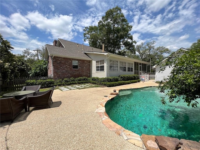 view of swimming pool with a patio area