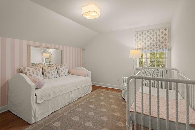 bedroom with hardwood / wood-style flooring and lofted ceiling