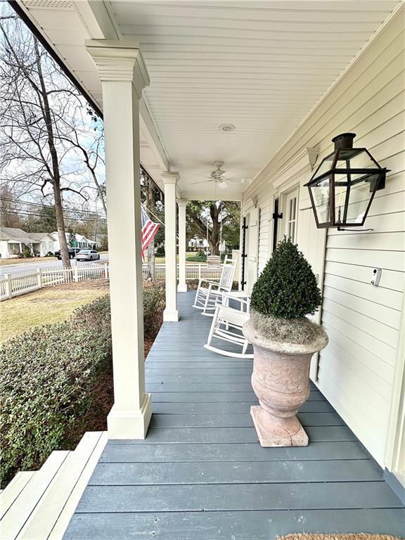 wooden deck featuring ceiling fan and a porch