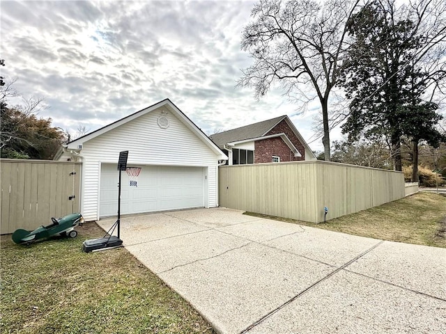 view of side of property with a garage, an outdoor structure, and a lawn