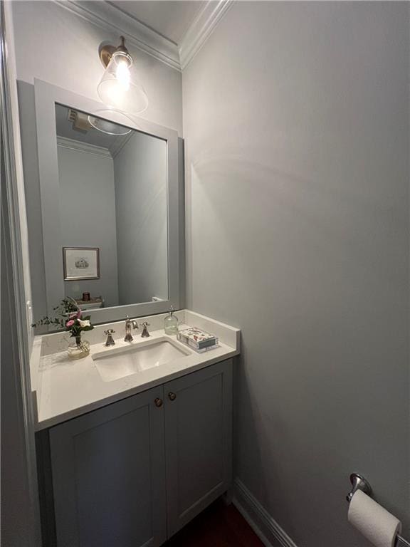 bathroom with ornamental molding and vanity