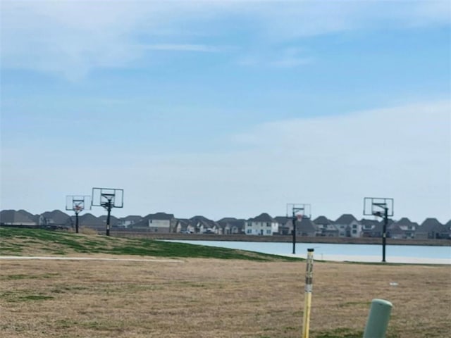 view of sport court featuring a water view