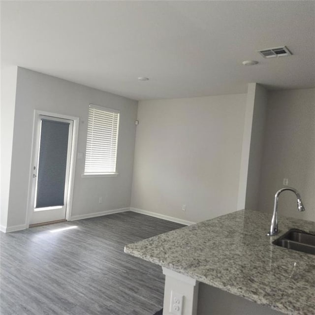 5574 Grand Springs Rd, Slidell, LA 70461 - kitchen with a sink, dark wood finished floors, baseboards, and light stone counters